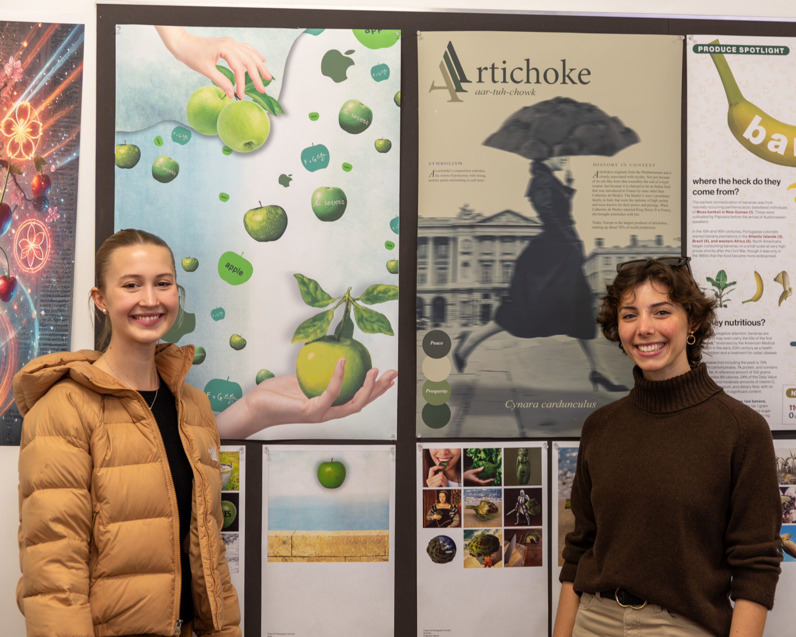 Two graphic design students pose with their work